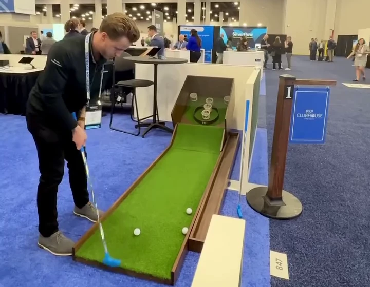 Close-up of a portable mini-golf putting lane with a guest lining up a putt