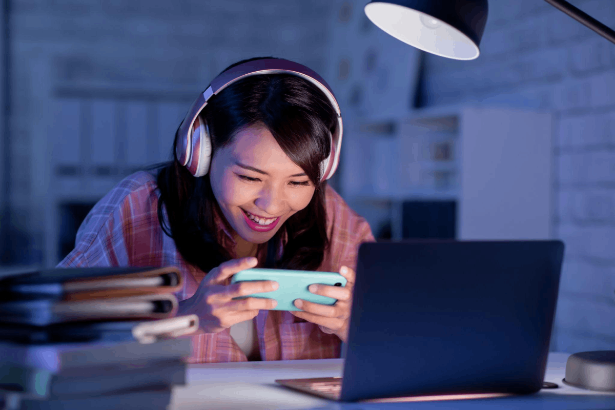 A woman in her 30s casually playing a game on her phone
